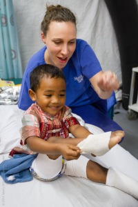 Prinscio helping put on his own plaster casts. . Pic Justine Forrest